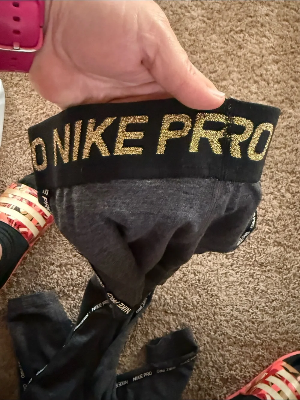 Nike women’s Charcoal Gray leggings with gold Swoosh